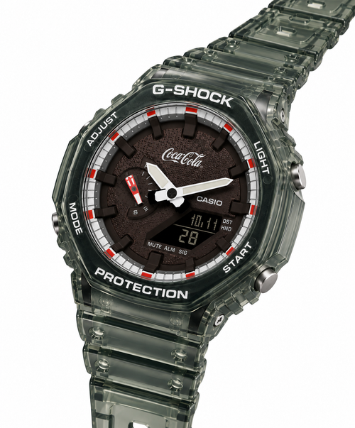 Coca-Cola-design GA-2100 watch with a translucent green strap, angled view