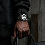 Silver-dial Klaw watch worn with a black sweater