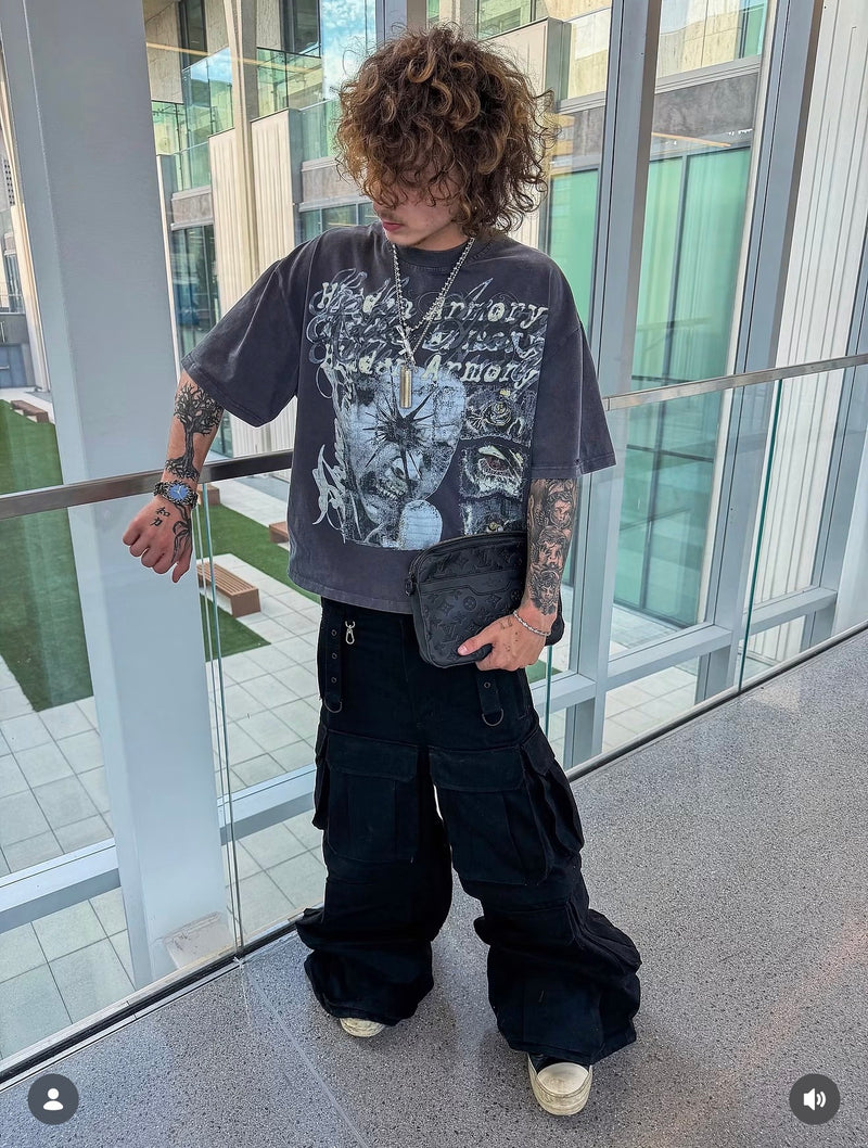 A blue-dial Klaw watch styled with a gray graphic T-shirt and black cargo pants