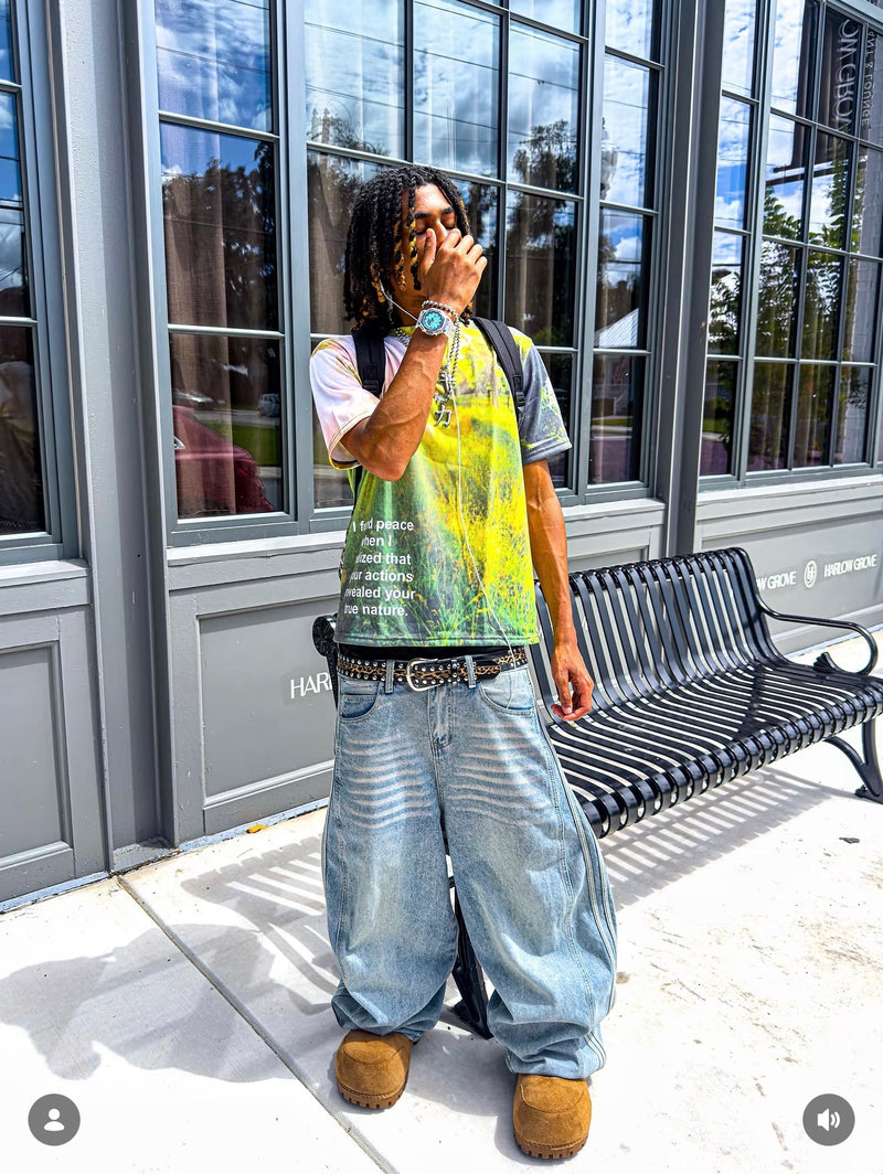 A turquoise-dial watch styled with a yellow graphic T-shirt and loose jeans