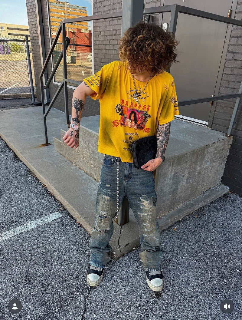A pink-dial Klaw watch styled with a yellow graphic T-shirt and jeans