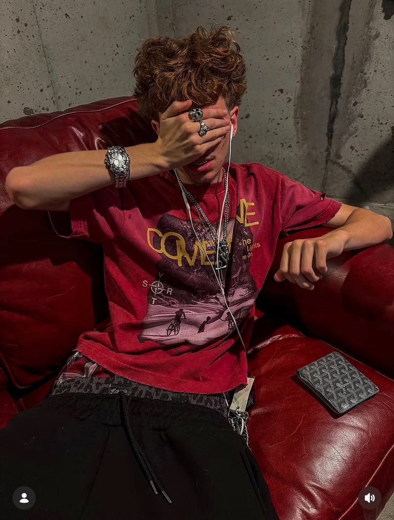 A silver Klaw watch styled with a red graphic T-shirt