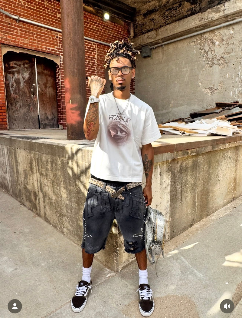 A silver watch styled with a white graphic T-shirt and black shorts